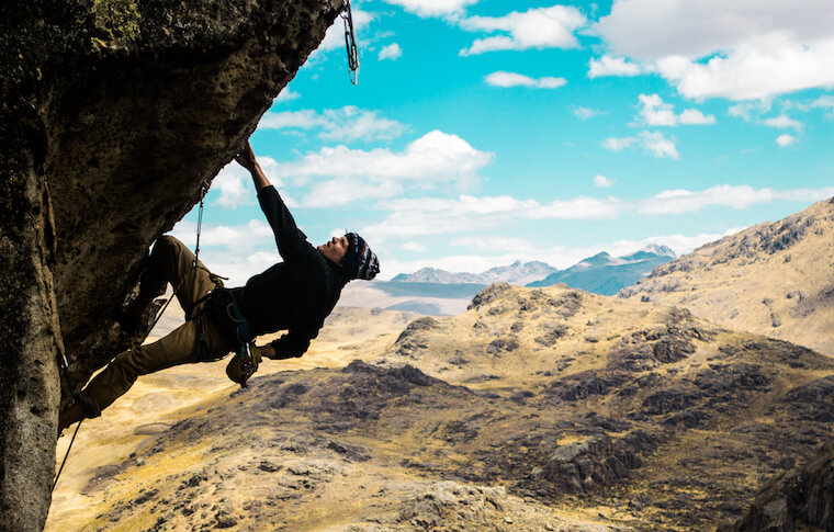 A climber hanging off a cliff